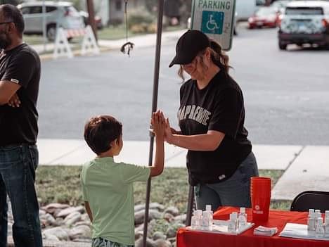 A volunteer and a kid high-fiving